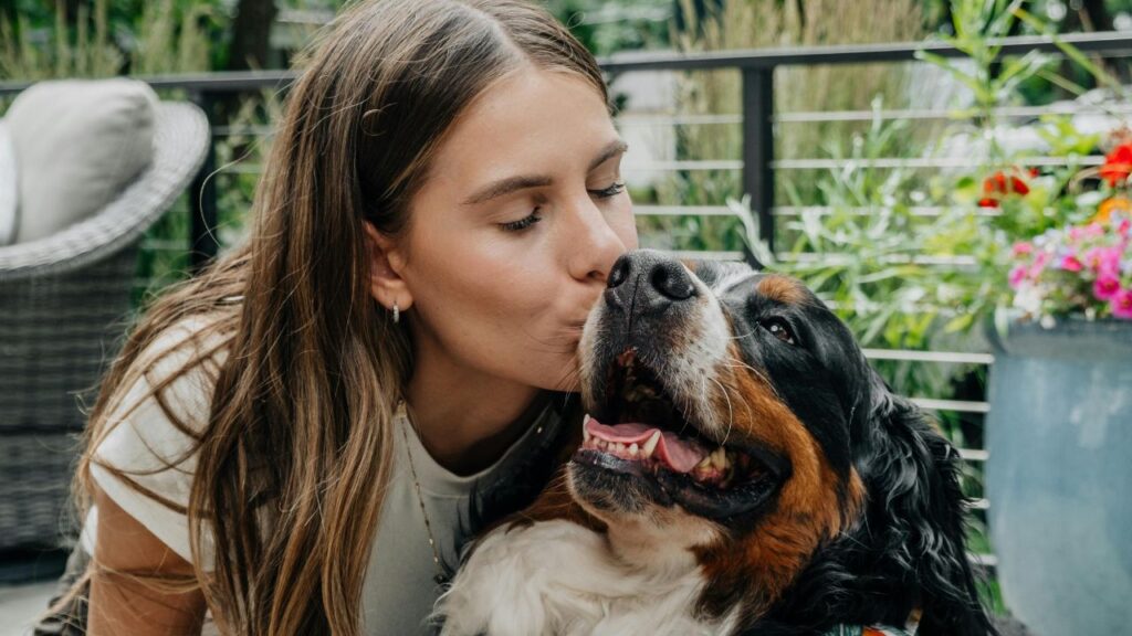woman kissing dog