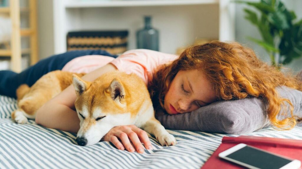 A girl with a dog sleeping peacefully