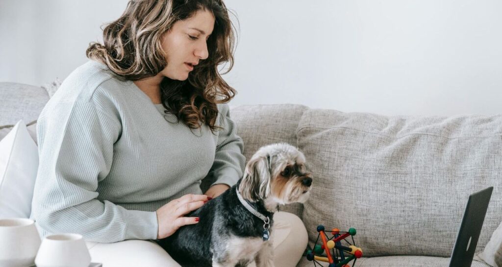 Woman watching movie with a dog
