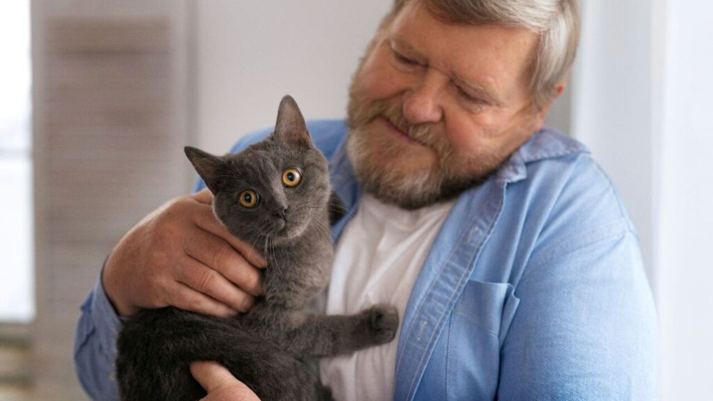 Man cuddles with a cat