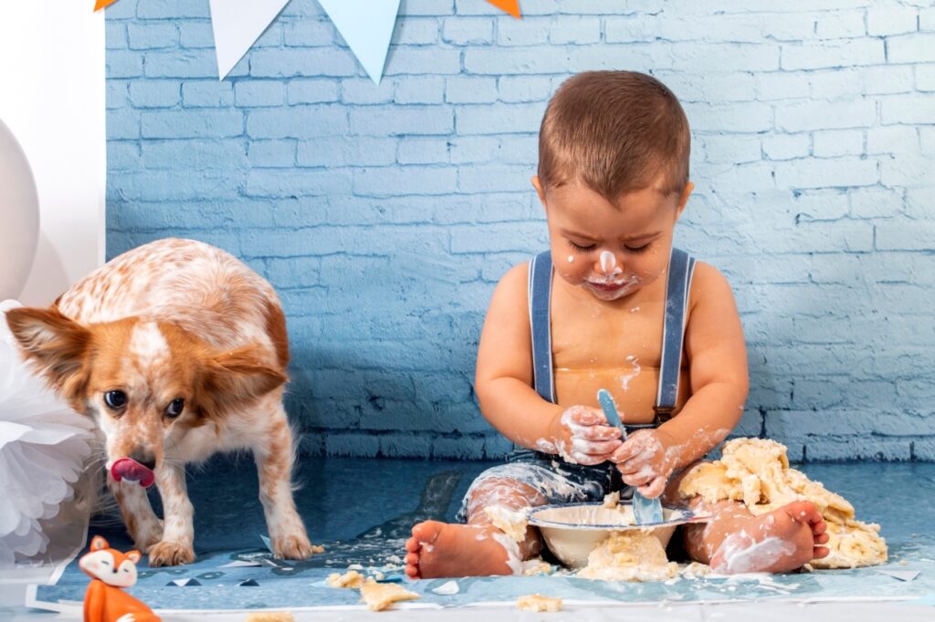 Kid eating cake with dog