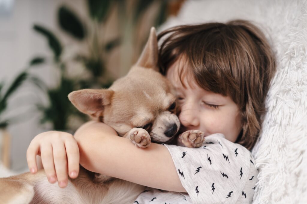 Kid hugging a dog