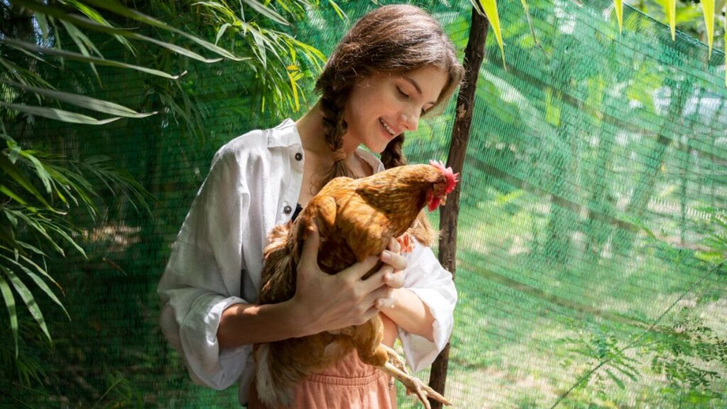A young woman holding chicken