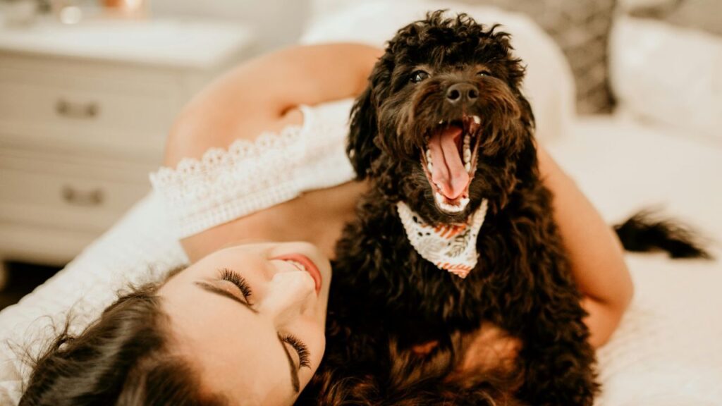 A woman and a dog in joyful mood