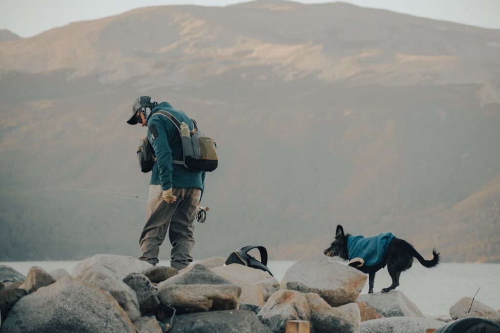 A man and a dog hiking together