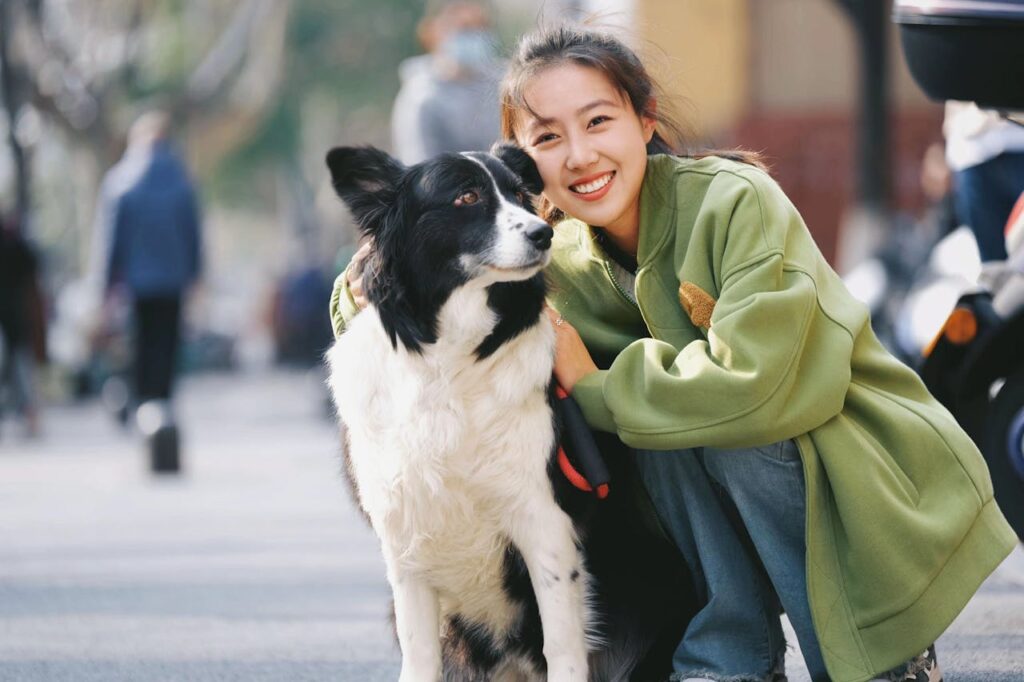 Smiling Woman Posing with Border Collie