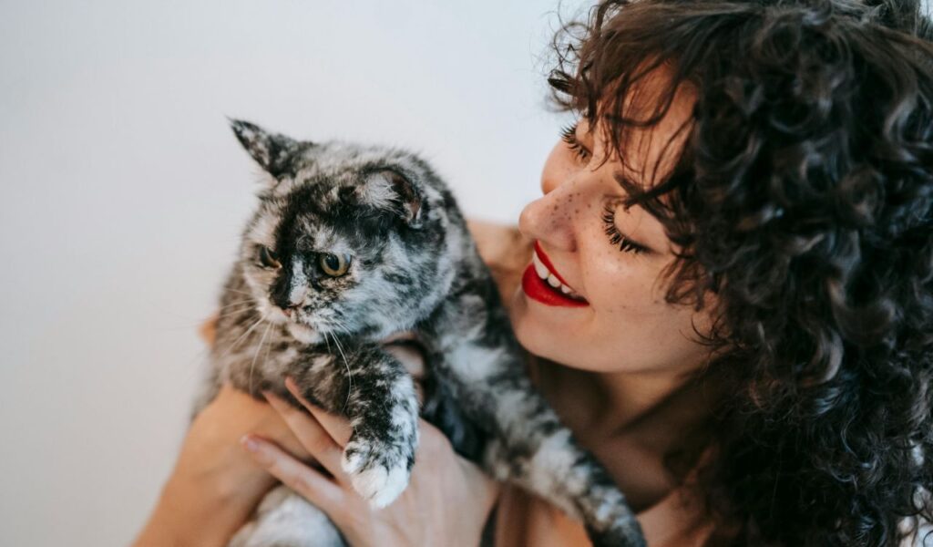 Woman holding a cat.