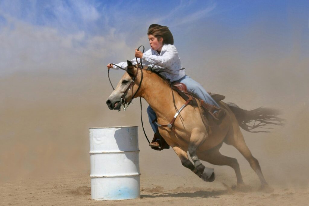 A woman riding a quarter horse