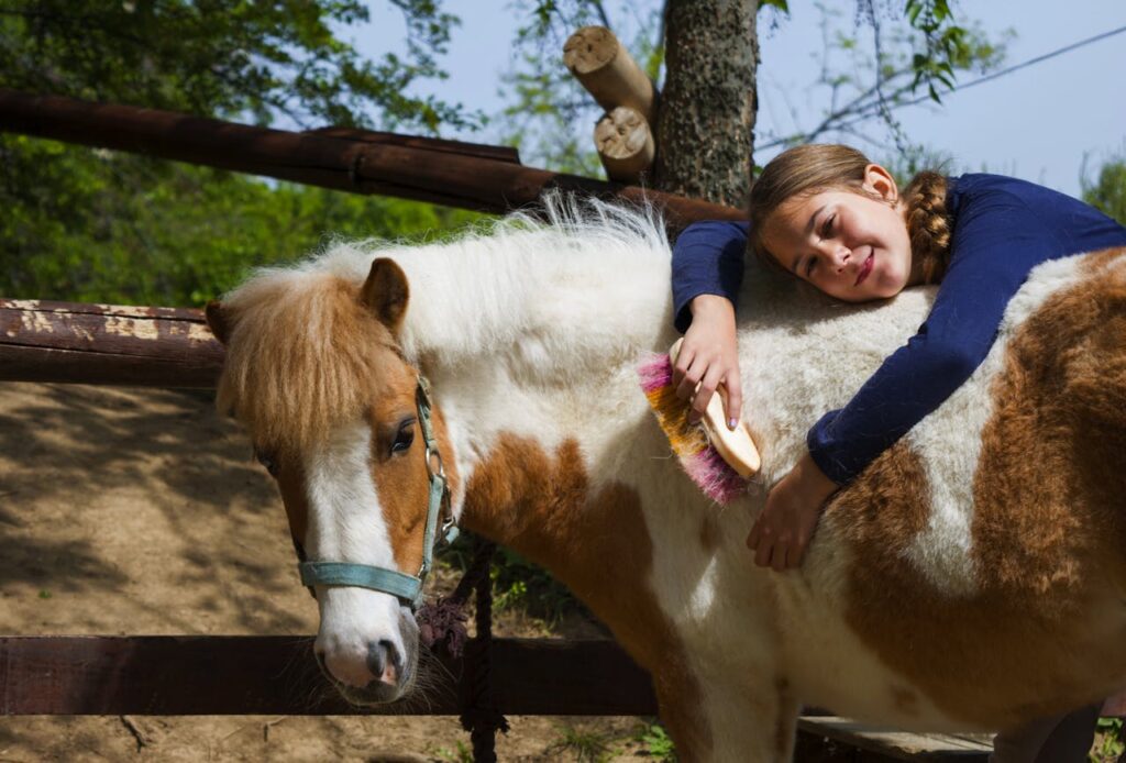 happy-girl-posing-with-a-pony-