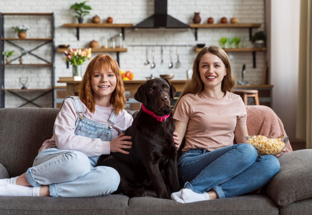 Full shot smiley women and Labrador dog