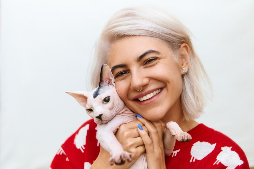 Woman with sphinx cat