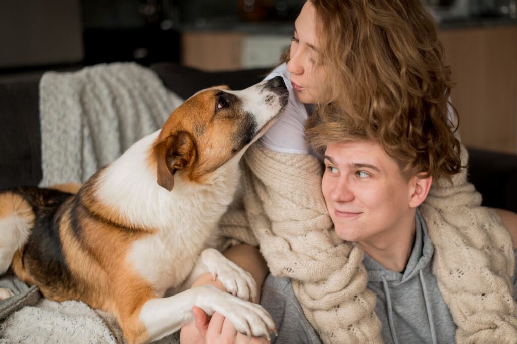 dog nuzzling couple