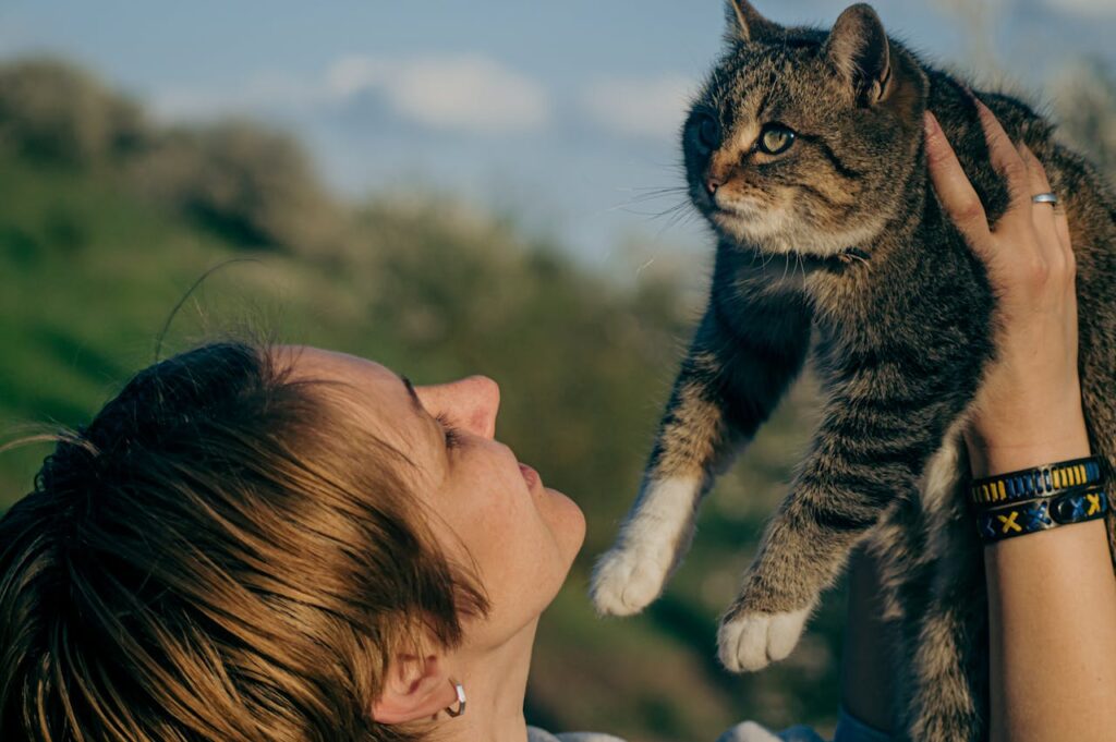 Woman Holding Up a Cat