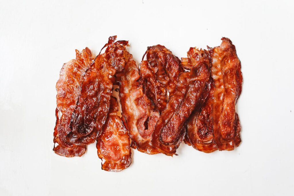 Dog eating bacon