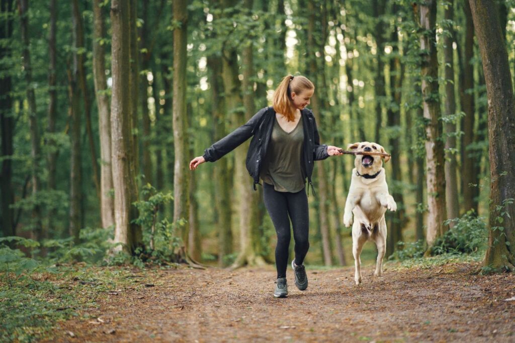 woman with dog taking a walk