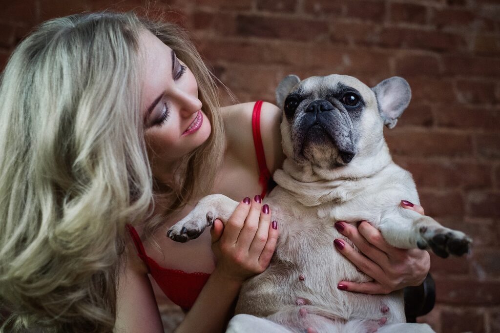 young woman holding a french bulldog