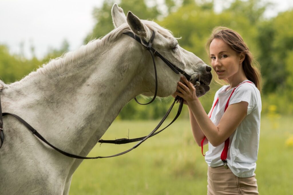 woman petting horse