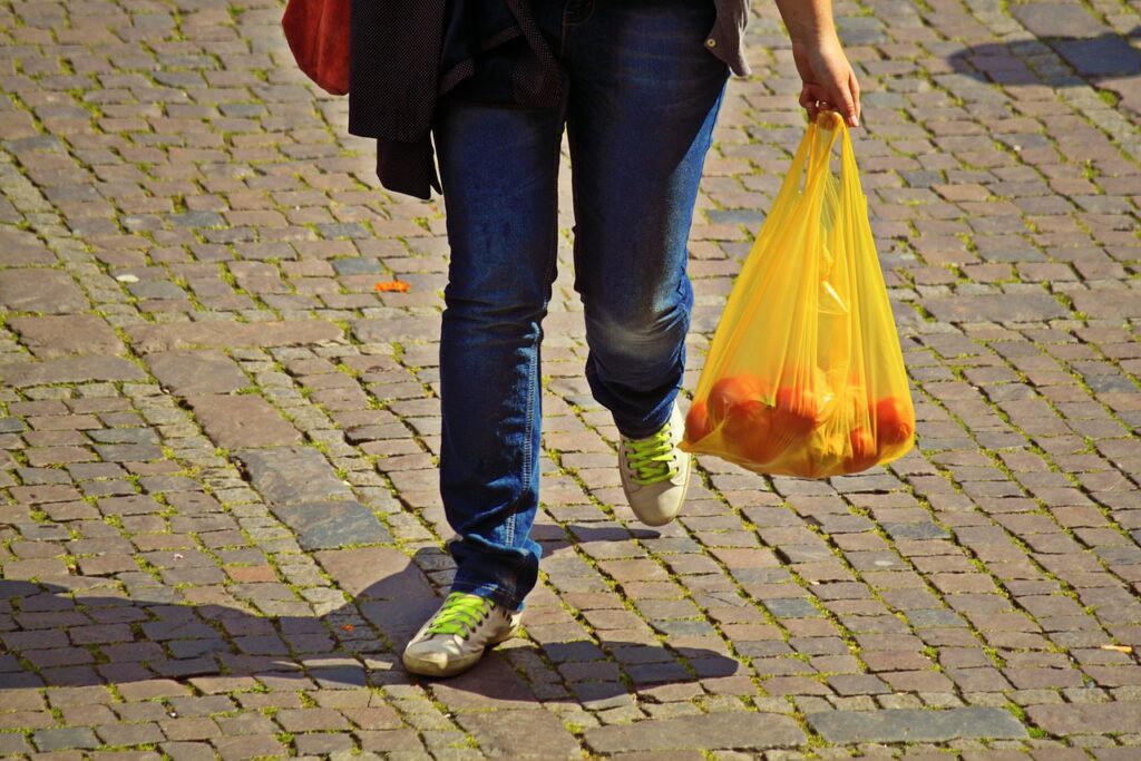  A Man carrying a plastic bag