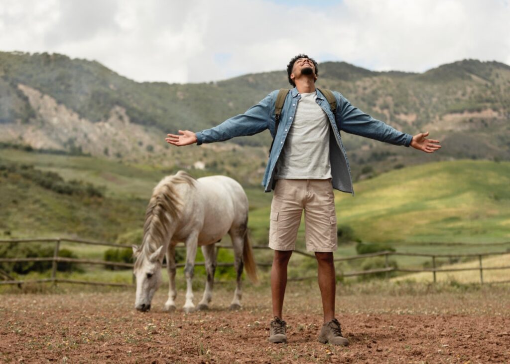 Man with a horse in background
