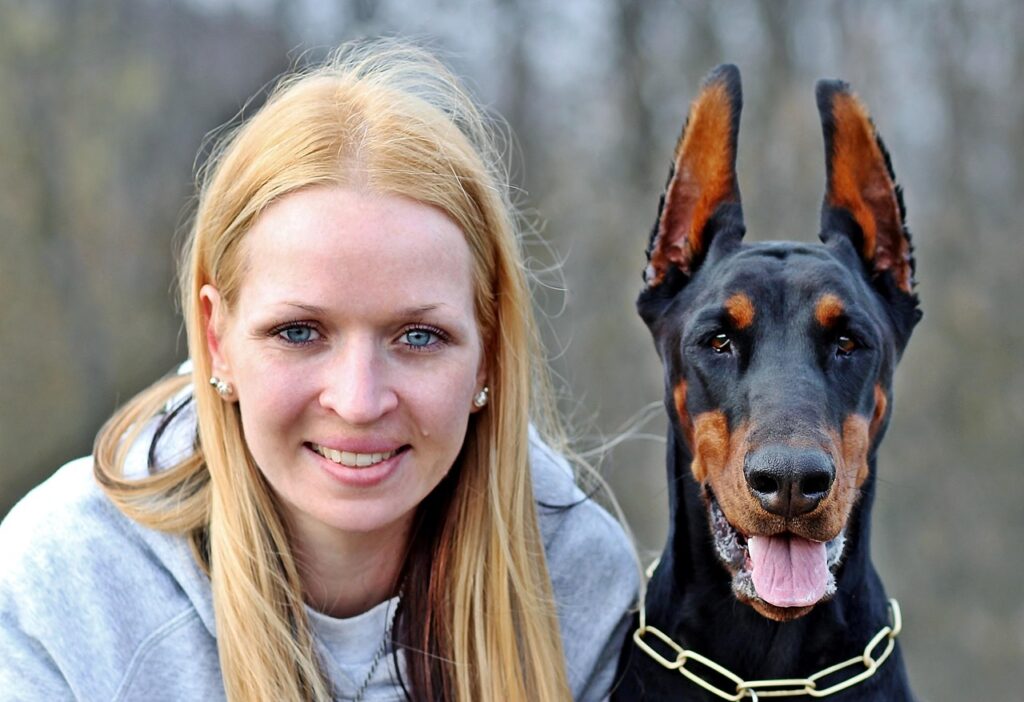 dobermann with woman