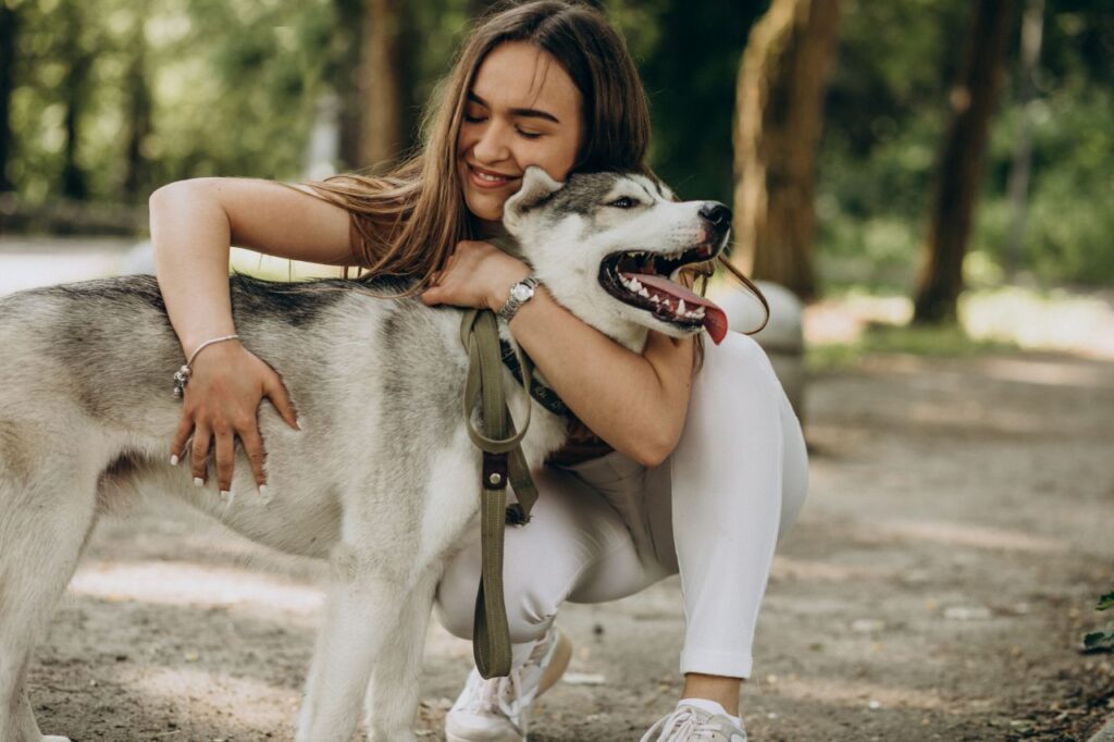 woman hugging her husky