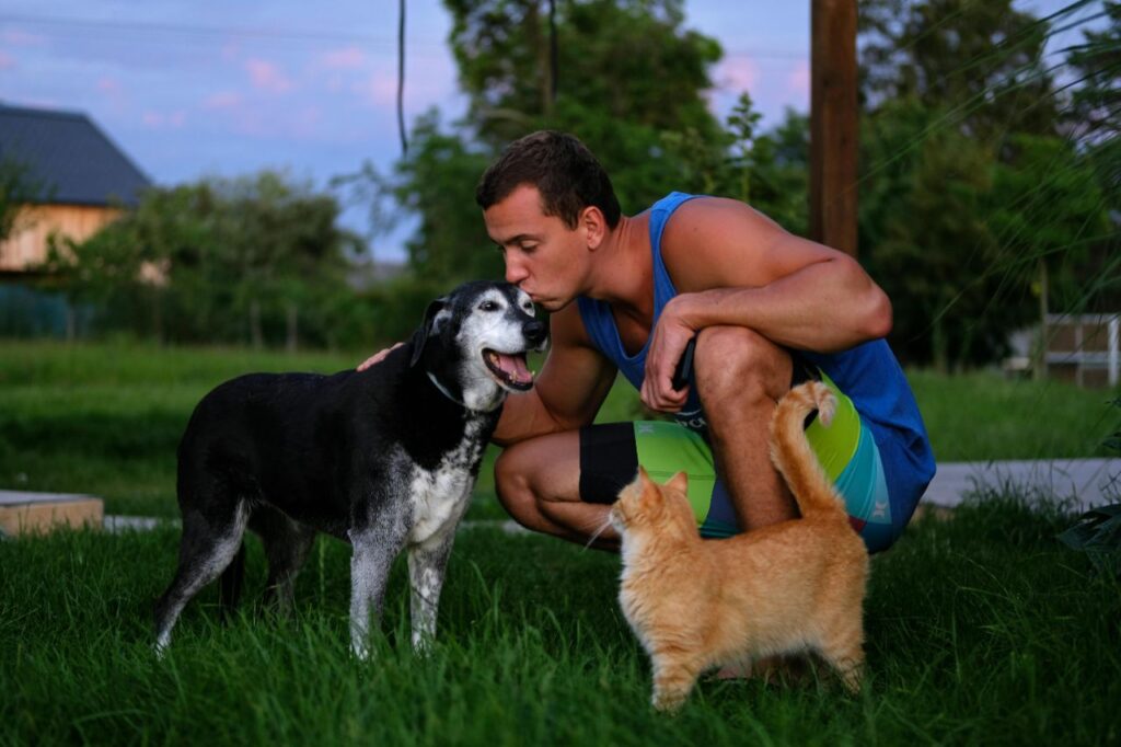Cat and dog with owner