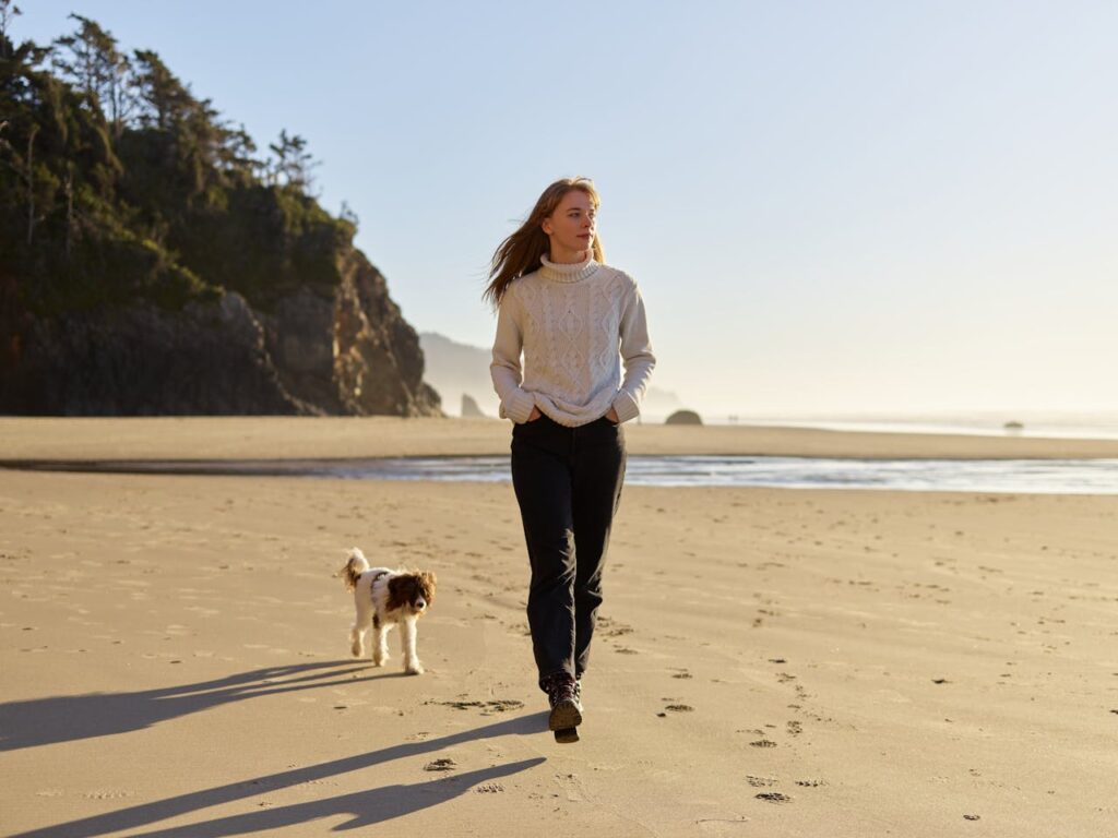 a-dog-following-the-woman-in-the-beach-