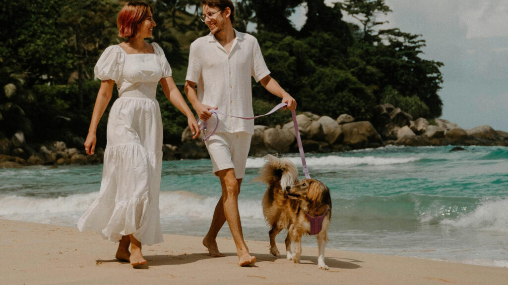 Couple with dog on beach
