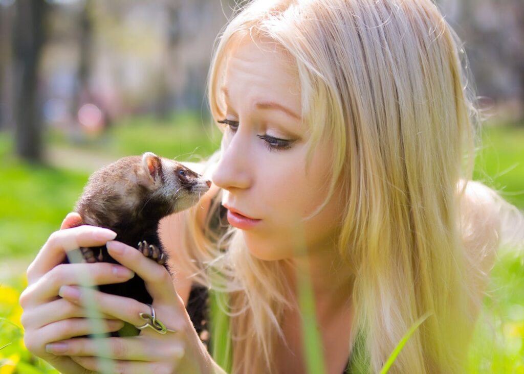 women holding a ferret