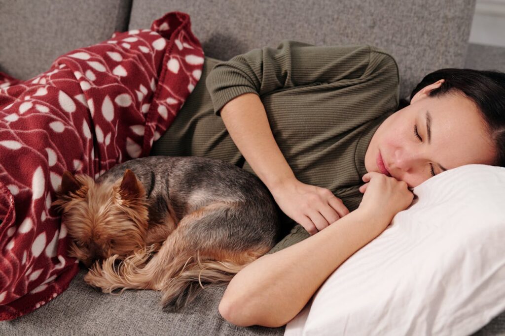 Dog and human sleeping together